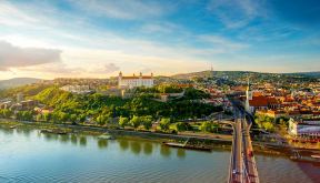 Bratislava aerial cityscape view on the old town with Saint Martin's cathedral, castle hill and Danube river on the sunset in Slovakia. Wide angle view with copy space